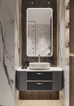 a bathroom with marble walls and flooring has a large mirror above the sink that is illuminated by lights