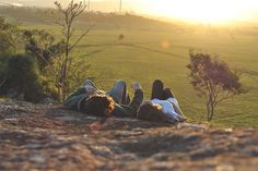 two people laying on the ground with their feet up