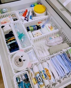 an organized drawer filled with baby items