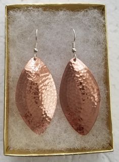 Oval hammered copper earrings with sterling silver ear wires. My unique hammering technique domes them a little and hardens the metal a little so they hold their shape well. They are available in 3 sizes, small, about 1&1/4 inch long, medium, a little under 1&3/4 inches, and large, just over 2 inches long. These are the sizes of the hammered piece, add about a half inch for the ear wire. The manikin is smaller than life size and the medium earring displayed actually appears large. Shippe Hammered Copper Earrings, Earring Display, Hammered Copper, Copper Earrings, Life Size, Ear Wire, Ear Wires, 4 Inch, Etsy Earrings