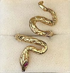 1940'S BULGARI SNAKE STYLE DESIGNER’S HAND ENGRAVED RING WITH RUBIES  IN SOLID YELLOW GOLD - $6K APPRAISAL VALUE! ITEM DESCRIPTION: The joy of wearing a piece of art on your finger is within reach when you grab this stunning designer’s Bulgari Snake style Cocktail Ring! This Solid Yellow Gold ring has unique hand engraved details with Rubies. Round shape Rubies are approximately 3 points each. It's an extraordinarily rare and beautiful ring which has an exceptional collector's antique look. This is a truly spectacular piece that could easily become a family heirloom! stamped '14K'   This ring measures approximately size 7.5 The overall weight is approximately 7.6 grams. This timeless piece will ship exactly as photographed in Excellent, Like New Condition. This ring also comes with: FREE $ Hand Engraved Rings, Serpent Ring, Engraved Ring, Family Heirloom, Ruby Ring, Engraved Rings, Hand Engraving, Cocktail Ring, Cocktail Rings