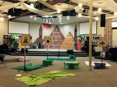 the stage is set up for an event with green tarps on the floor and white walls