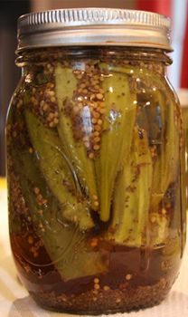 a jar filled with pickles sitting on top of a table