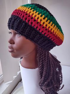 a mannequin head wearing a multicolored crochet beanie hat