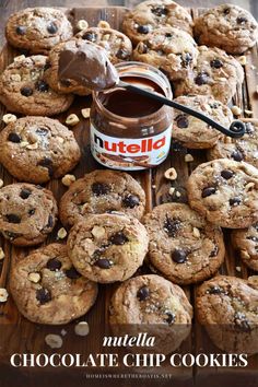 nutella chocolate chip cookies are on a wooden tray with a jar of nutella