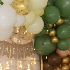 balloons and garlands are on display at a mardi gras party