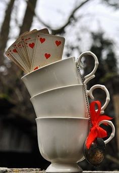 a stack of cups with playing cards in them