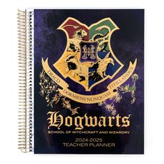 a harry potter notebook with the hogwarts crest on it