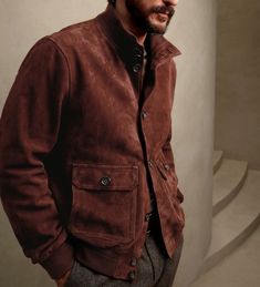 Classic meets contemporary: Make a statement in this stylish brown suede bomber jacket. #brownjacket #suedejacket Brown Varsity Jacket With Pockets For Fall, Fall Varsity Jacket With Stand Collar And Pockets, Fall Collared Varsity Jacket With Pockets, Casual Brown Outerwear With Ribbed Collar, Classic Brown Winter Varsity Jacket, Masculine Winter Outerwear With Pockets, Classic Brown Varsity Jacket For Fall, Classic Brown Long Sleeve Varsity Jacket, Masculine Long Sleeve Outerwear For Fall