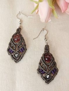 "Macrame earrings, in gray and purple color, with purple glass bead. Bohemian earrings handmade with high quality waxed thread, water and sun-resistant. For women with unique and alternative style. Dimensions : 2.5\"  ⁎Product color may slightly vary due to photographic lighting sources or your monitor settings." Handmade Bohemian Purple Crystal Earrings, Purple Flower Bohemian Earrings, Purple Macramé Bohemian Jewelry, Bohemian Purple Droplet Chandelier Earrings, Bohemian Purple Tassel Earrings, Macrame Earrings, Bohemian Earrings, Purple Glass, Etsy Earrings Dangle