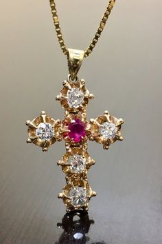 DeKara Designs ClearanceArt Deco Inspired Antique Style 14K Yellow Gold Old European Cut Diamond and Ruby Cross.Metal- 14K Yellow Gold, 14K White Gold, .583.Stones- 5 Antique Old European Cut Diamonds E-F Color VS Clarity, 2.10 Carats, 1 Oval Genuine Ruby 1.20 Carats.  Total Weight of Stones is 3.30 Carats.  This amazing piece is handmade in 14K yellow gold that is Art Deco inspired.  The cross features five antique Old European Cut Diamonds that are colorless, with a beautiful reddish pink oval Antique Yellow Gold Diamond Cut Necklace, Collectible Diamond Necklace Fine Jewelry, Collectible Yellow Gold Diamond Necklace, Luxury Diamond Necklace For Collectors, Diamond Pendant Necklace For Collectors, Antique Yellow Gold Diamond Jewelry, Hallmarked Yellow Gold Ruby Jewelry, Collectible White Gold Diamond Necklace, Yellow Gold Ruby Jewelry Stamped 14k