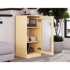 an open yellow cabinet in a living room next to a couch and potted plant