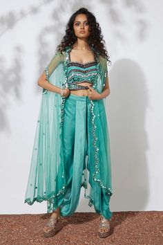 Aqua blue bustier with all-over sequin embellishments, mirror embroidery, cutout at the front and sweetheart neckline. Comes with cape and dhoti pant.
Component: 3
Embroidered, Embellished
Neckline: Bustier: Sweetheart; Cape: Open
Sleeve Length: Bustier: Sleeveless; Cape: Three Quarter
Fabric: Crepe, Net
Color: Blue
Thread, beads, sequin, mirror and pearl embroidery
Embellished cape with scallop edge
Closure:
Dhoti pant: Concealed hook and zip closure at the front - Aza Fashions Cape Set, Embroidered Cape, Dhoti Pants, Indian Couture, Open Sleeve, Indian Fashion Designers, Indian Fashion Dresses, Aqua Green, Pant Set