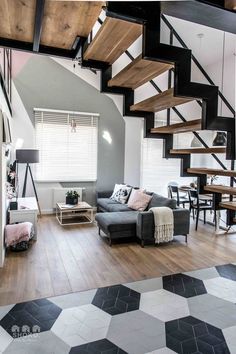 a living room filled with furniture next to a stair case