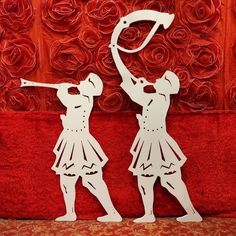 two paper cut figures are standing next to each other, one is holding a baseball bat