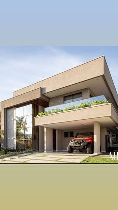 a car is parked in front of a modern house with plants growing on the roof