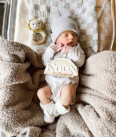 a baby is laying in a clear box with a name tag on it's chest