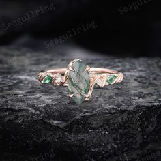 Marquise cut Moss agate ring unique rose gold 14k Moss agate engagement ring Emerald ring Moissanite Leaf Twig ring Bridal Promise ring Each moss agate is different, and after you place an order, we will send some moss agate for you to choose from, to ensure that you will get a perfect ring. ✨ Unique Handcrafted Ring with Gemstone Charm ✨ -Ring Details: The center stone is a 5x10 mm marquise cut moss agate. The side stones are about 0.09 ct moissanite and lab emerald. The width of this band is 1 Moosachat Ring, Engagement Ring Emerald, Moss Agate Engagement Ring, Twig Ring, Agate Engagement Ring, Ring Marquise, Unique Roses, Moss Agate Ring, Ring Emerald