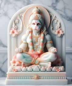 there is a statue of the hindu god sitting in front of a marble wall with flowers on it