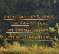 the words are written in bright orange and black ink on a green background with trees