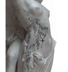 the back of a statue with flowers on it