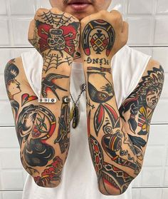 a man with many tattoos on his arms