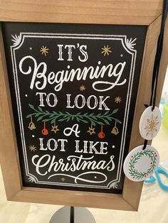 a chalkboard sign that says it's beginning to look a lot like christmas