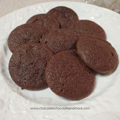 chocolate cookies are arranged on a white plate