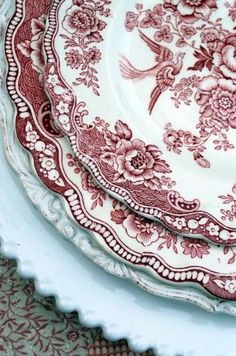 red and white plates stacked on top of each other in a stack with floral designs