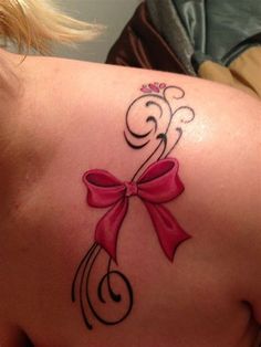 a woman with a pink bow tattoo on her back