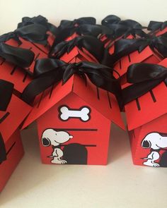 some red boxes with black bows and a dog house on them are decorated to look like houses