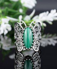 Elevate Your Collection with the Filigree Art Silver Butterfly Ring Featuring Malachite Gemstone A Timeless Piece of Craftsmanship Discover the exquisite charm of our handmade Filigree Art Silver Butterfly Ring enhanced with a captivating Malachite Gemstone. Crafted from premium 925 sterling silver, this timeless cocktail ring boasts a face measuring 0.80 inches in length and 0.70 inches in width. It's a harmonious blend of delicacy and allure. Malachite's Elegance The Malachite Gemstone graces Silver Butterfly Ring, Butterfly Ring, Butterfly Jewelry, Sterling Silver Filigree, Silver Butterfly, Hand Crafted Gifts, Ring Women, Silver Filigree, Cocktail Ring