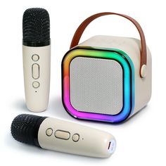 two microphones are next to a speaker with a rainbow design on the front and side