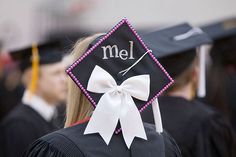 a graduate's cap with the word mel on it and a bow at the back