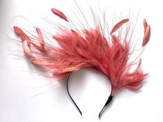 Dusky pink feather fascinator This lovely dusky pink feather fascinator is made from high-quality feathers which are attached to the fabric-covered metal headband. A dusky pink feather fascinator can be suitable for the Bridesmaid, Mother of the Bride, Garden party, or a Lady's day at the races.  The pink feather fascinator will fit an average head size  Enjoy your special day with this beautiful fascinator! Baby Pink Wedding, Navy Fascinator, Gold Hair Piece, Pink Halo, Wedding Halo, Fascinator Wedding, Kentucky Derby Fascinator, Pink Fascinator, Derby Fascinator