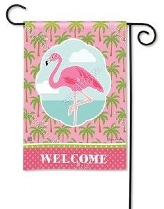 a pink flamingo flag hanging from a pole