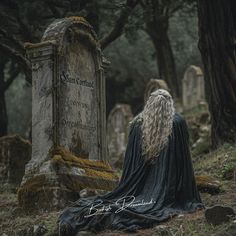 a man with long white hair sitting in front of a gravestone wearing a black cloak