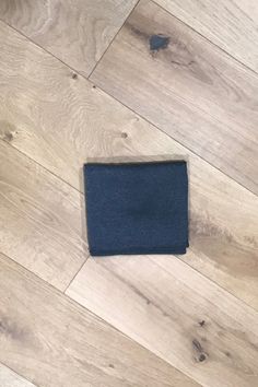 a blue piece of cloth sitting on top of a wooden floor