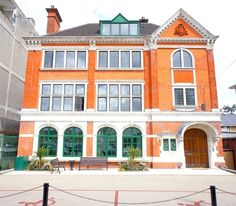 an orange brick building with lots of windows