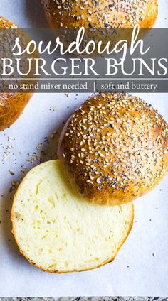 two loaves of sourdough burger buns on top of each other with sesame seed sprinkles