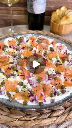 a pizza sitting on top of a table next to a glass of wine and bread