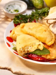 a white plate topped with fried food and vegetables