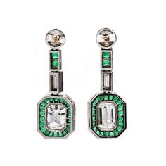 These Art Deco drop earrings are just beautiful! Each earring is made of platinum with a 14K yellow gold post and holds a bezel set European cut diamond at its top, from which a vertical bar with two square cut emeralds and a vertical bar with a single baguette diamond are suspended. The bottom pendant is a bezel set emerald cut diamond surrounded by a halo of twenty-two square or keystone shape step cut natural emeralds. Now that all the technical jargon's out of the way, we can only say that w Platinum Art Deco Earrings For Anniversary, Art Deco Platinum Earrings For Anniversary, Anniversary Platinum Art Deco Earrings, Elegant Emerald Cut Single Diamond Earrings, Luxury Bezel Set Drop Earrings, Luxury Bezel-set Drop Earrings, Art Deco Drop Earrings, Vertical Bar, Colorless Diamond