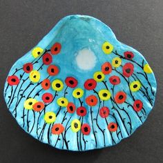 a blue bowl with red and yellow flowers painted on it