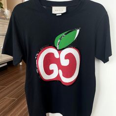 New With Tags, Purchased For 690 Plus Tax Designer Gucci Black T-shirt, Gucci Black Crew Neck Top, Gucci Black T-shirt With Logo Print, Gucci Designer Black T-shirt, Gucci Black Short Sleeve Tops, Black Gucci Short Sleeve T-shirt, Casual Red Gucci Tops, Designer Red Tops With Logo Print, Red Gucci Cotton Top