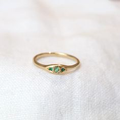 Our Trio ring in 14k, set with shimmering, bright green emeralds. A gorgeous low-profile ring in an enchanting tone. Materials: 14k yellow gold, green emeralds Elegant 14k Stamped Emerald Ring, Green Birthstone Ring Fine Jewelry, Green Three-stone Emerald-cut Emerald Ring, Green Three Stone Emerald Cut Emerald Ring, Three-stone Emerald Cut Green Emerald Ring, Green Emerald Cut Three Stone Emerald Ring, Green Emerald Cut Diamond Ring With Rose Cut Diamonds, Green Three-stone Birthstone Ring In 14k Gold, Green Three Stone Birthstone Ring In 14k Gold