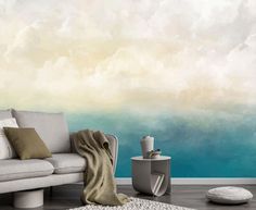 a living room scene with focus on the couch and wallpaper that looks like clouds