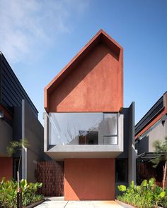 an orange and grey house with two levels