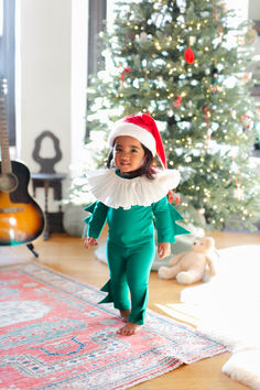 Celebrate the holiday season with this adorable, festive elf costume! With cozy cotton pajamas, a frilled collar and a warm Santa hat, it’s the cutest pajama for Christmas morning and wearable all winter long to warm up any chilly day. #christmas #holiday #christmaself #kidscottonpjs #christmaspjs #elfcostume Santa's Helper Costume, Elf Pajamas, Frilled Collar, Red Santa Hat, Pajama Costume, Baby Kostüm, Elf Costume, Create Picture, Santa Helper