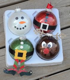 three christmas ornaments sitting on top of a white tray